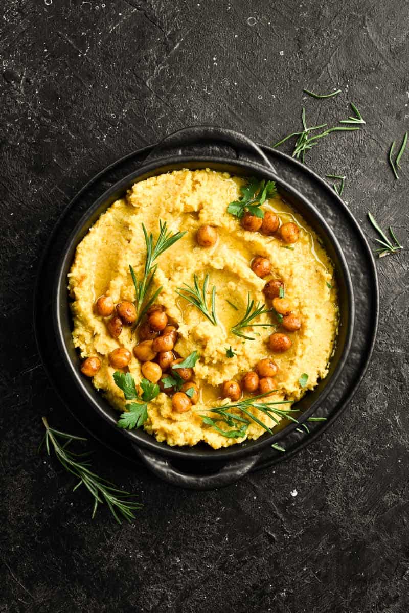 acorn squash hummus in the black bowl with rosemary