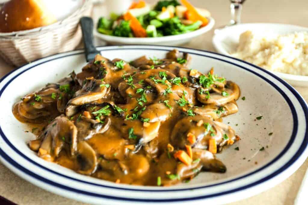 chicken and mushroom sauce dish on the white plate